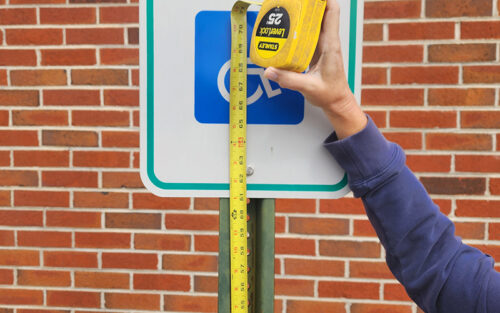 Measuring the height of an accessible parking sign